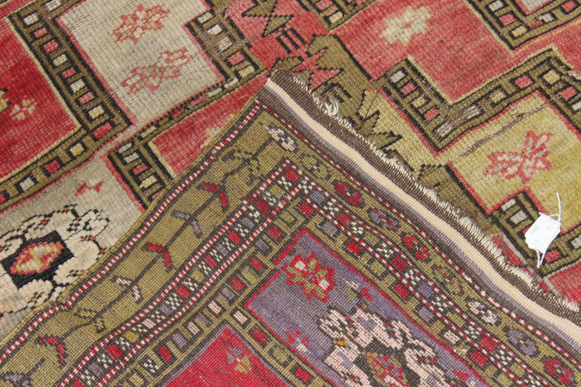 An early 20th Century hand knotted woollen rug, probably Uzbekistan - Image 3 of 4