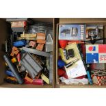 Four boxes of assorted model railway accessories and track to include carriages and rolling stock
