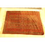 Pure wool Belouch rug dark red tones, geometric pattern with original Lee Longlands label,