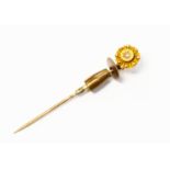 A Victorian 18ct gold stick pin, star set with a small diamond to the centre,