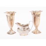 Pair of Sheffield silver fluted vases by Walker and Hall, dated 1922 and 1923,