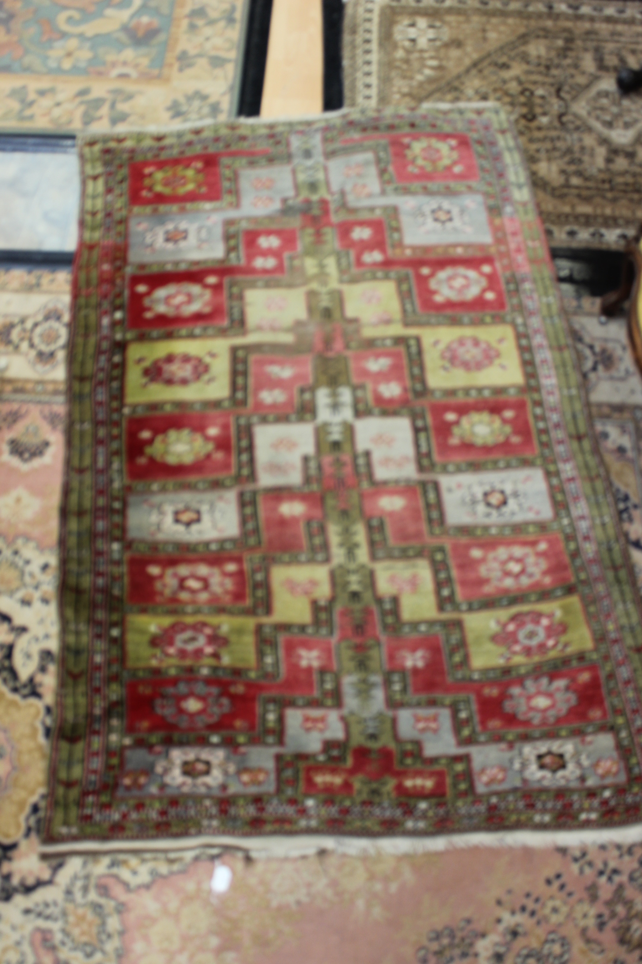 An early 20th Century hand knotted woollen rug, probably Uzbekistan - Image 2 of 4