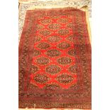 A cream hand knotted woollen rug, with red,