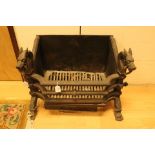 A 19th Century Empire style cast iron fire basket, with animal heads to each side,