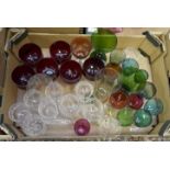 A collection of assorted decorative drinking glasses including claret glasses, coloured glassware,