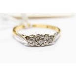 A diamond three stone illusion set ring in 18ct gold, size P, total gross weight approx 2.