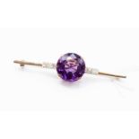 An amethyst and diamond set 18ct gold bar brooch, the central amethyst approximately 16mm diameter,