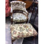 A late Victorian floral upholstered tub chair, together with a matching upholstered footstool,