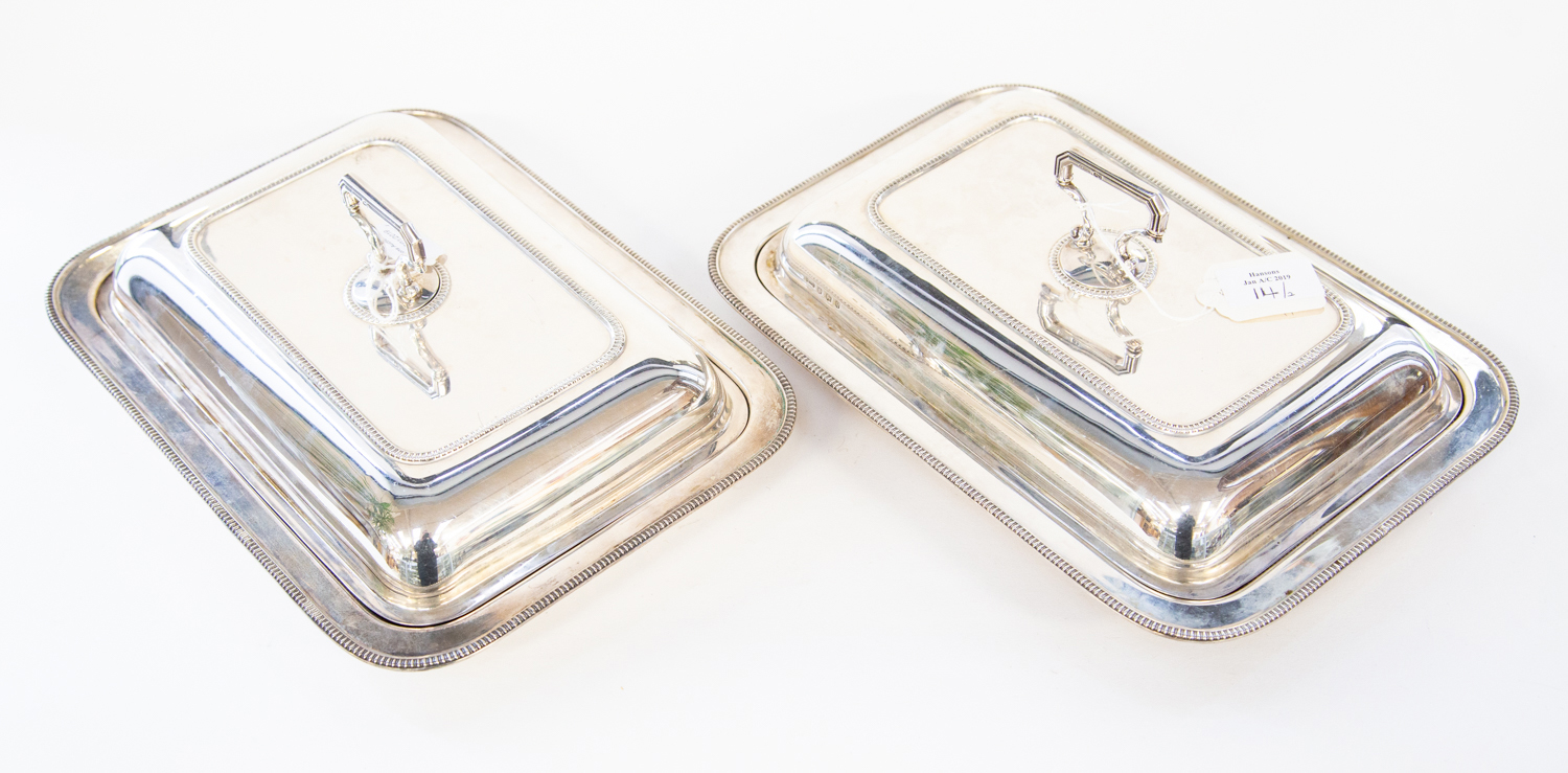 A pair of George V silver entree dishes, cover and handles, rectangular with gadroon edging,