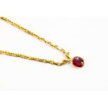 An 18ct gold chain with a garnet pendant, total gross weight approx 18.