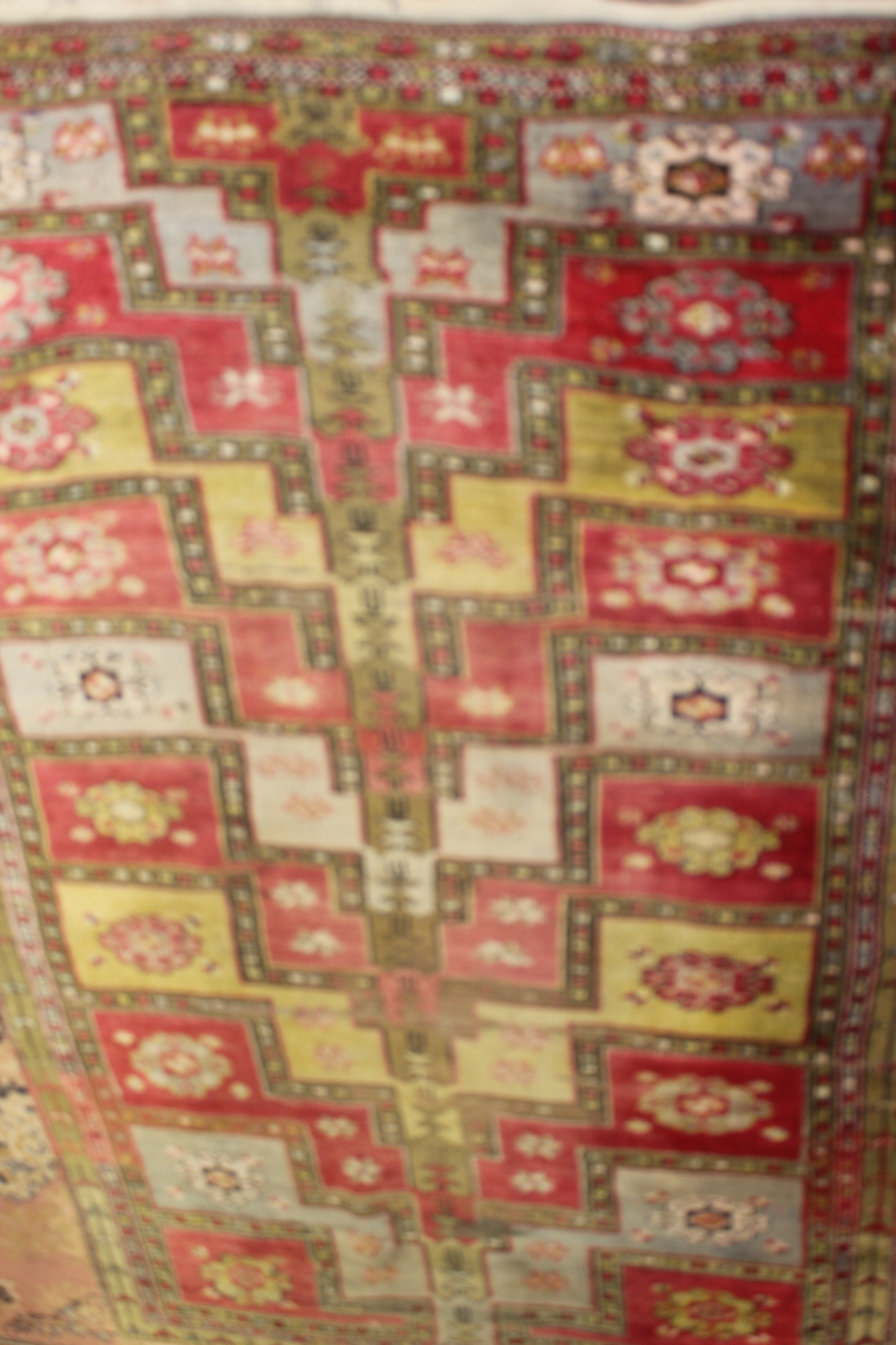 An early 20th Century hand knotted woollen rug, probably Uzbekistan - Image 4 of 4