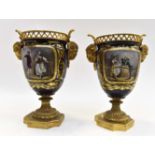 A pair of 19th century Sevres porcelain and ormolu mounted urns, depicting on courting couples,