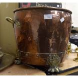 A Regency copper coal bucket with brass handles and lion paw feet