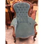 A Victorian button back armchair,