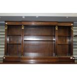 An Empire style mahogany breakfront open bookcase, bronzed capitals and feet, 79cm high, 140cm wide,