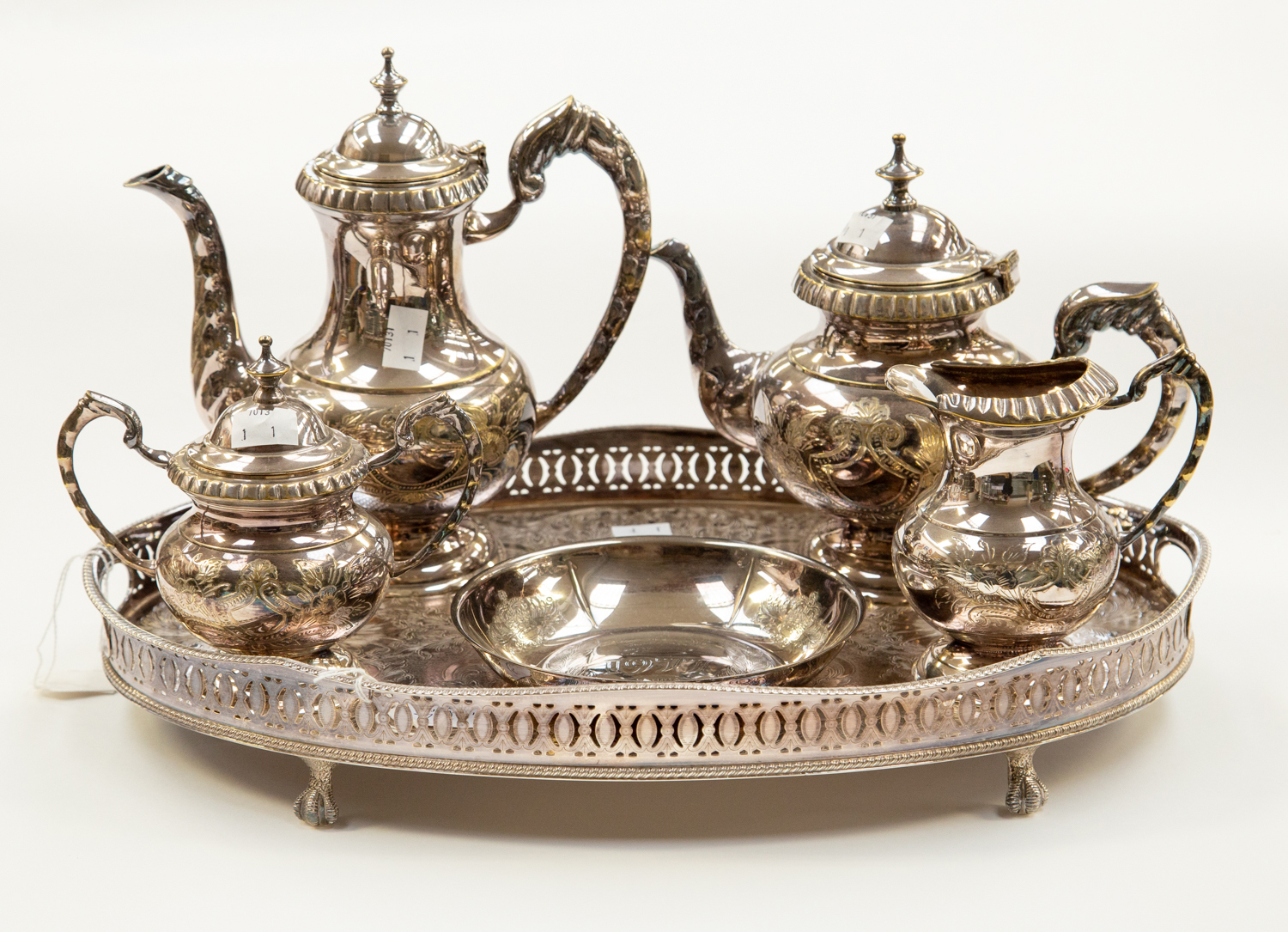 A collection of plated ware to include a gallery tray, tea pot, coffee pot, sugar bowl,