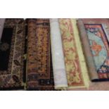 A collection of four various rugs, comprising 20th Century Aztec orange, black and red woollen rug,