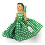 A rare composition upside down doll wearing green dress,