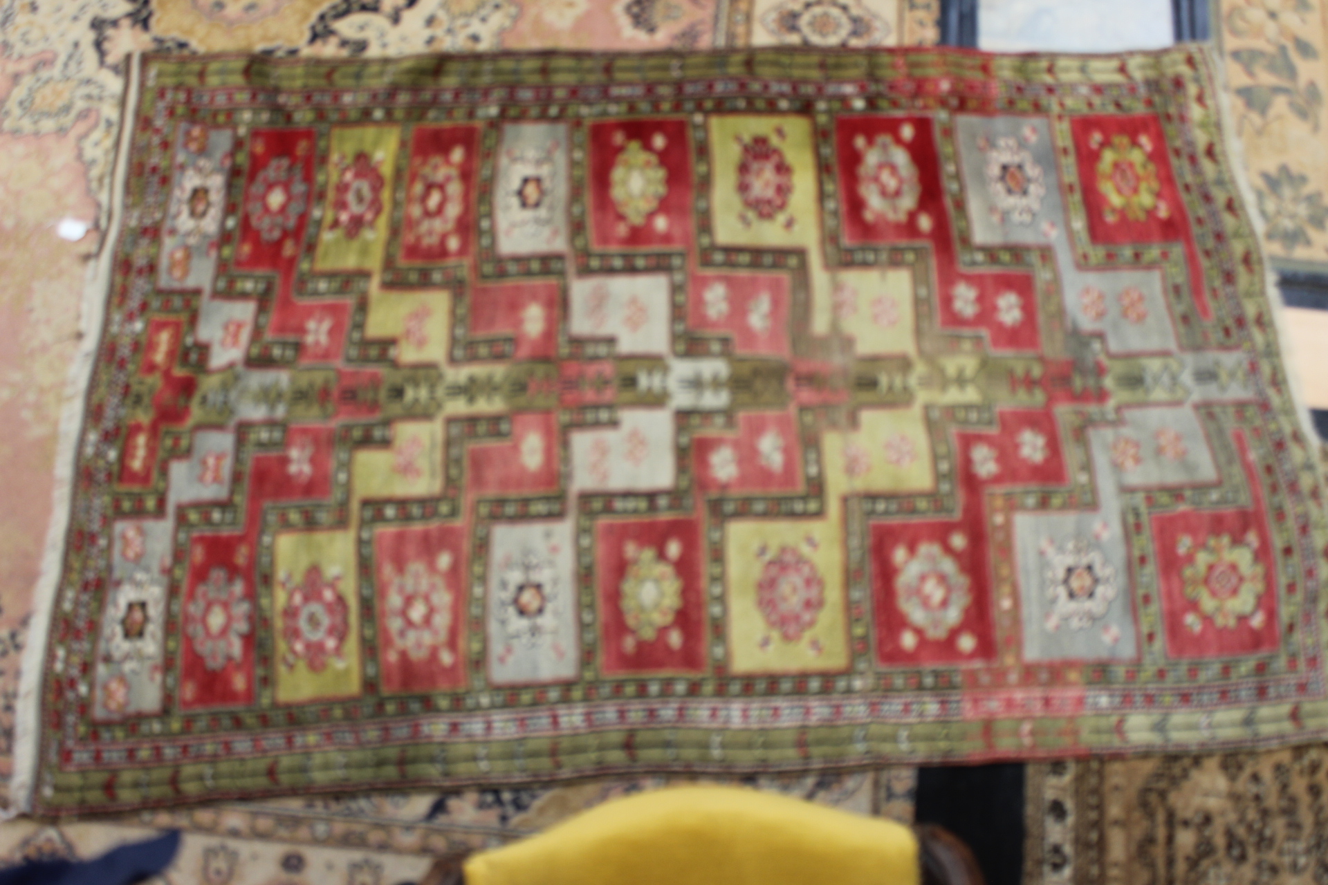 An early 20th Century hand knotted woollen rug, probably Uzbekistan