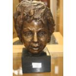 A 20th Century bronze study of a head on slate plinth base -head 22 cm high