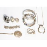 A collection of various silver jewellery, comprising locket and chain, gemstone set bangle,