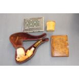 A cased Meerschaum pipe with a broken amber mouthpiece, together with a bone inlaid card case,