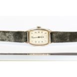 A silver cased Art Deco silver gents watch, marked Edinburgh, elongated white enamelled dial,