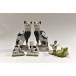 A pair of pottery cats, two small porcelain dogs,