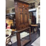 A 19th Century oak and mahogany free standing corner cupboard, fitted with two doors,