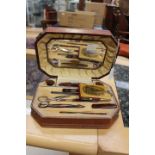 A circa 1920's tan leather reptile skin design manicure set, celluloid implements,