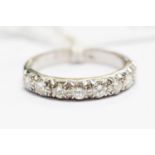 A diamond half set eternity ring, with eight brilliant-cut diamonds in white metal mount,