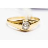 A diamond solitaire 18ct gold ring, the oval rub-over set old cut diamond approx 0.