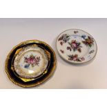 A Royal Crown Derby plate, painted in coloured enamels with a spray of flowers and leaves,