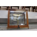 A microid mahogany cased weighing scale, glass panels,