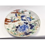 A large Japanese Meiji period (1868-1912) porcelain charger, decorated with birds,