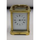 A brass carriage clock, of traditional rectangular form,