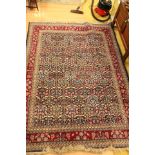 A 20th Century hand knotted woollen rug, in burgandy, cream patterns throughout,