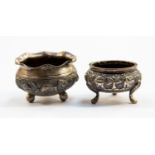 Two Indian white metal pots both footed,