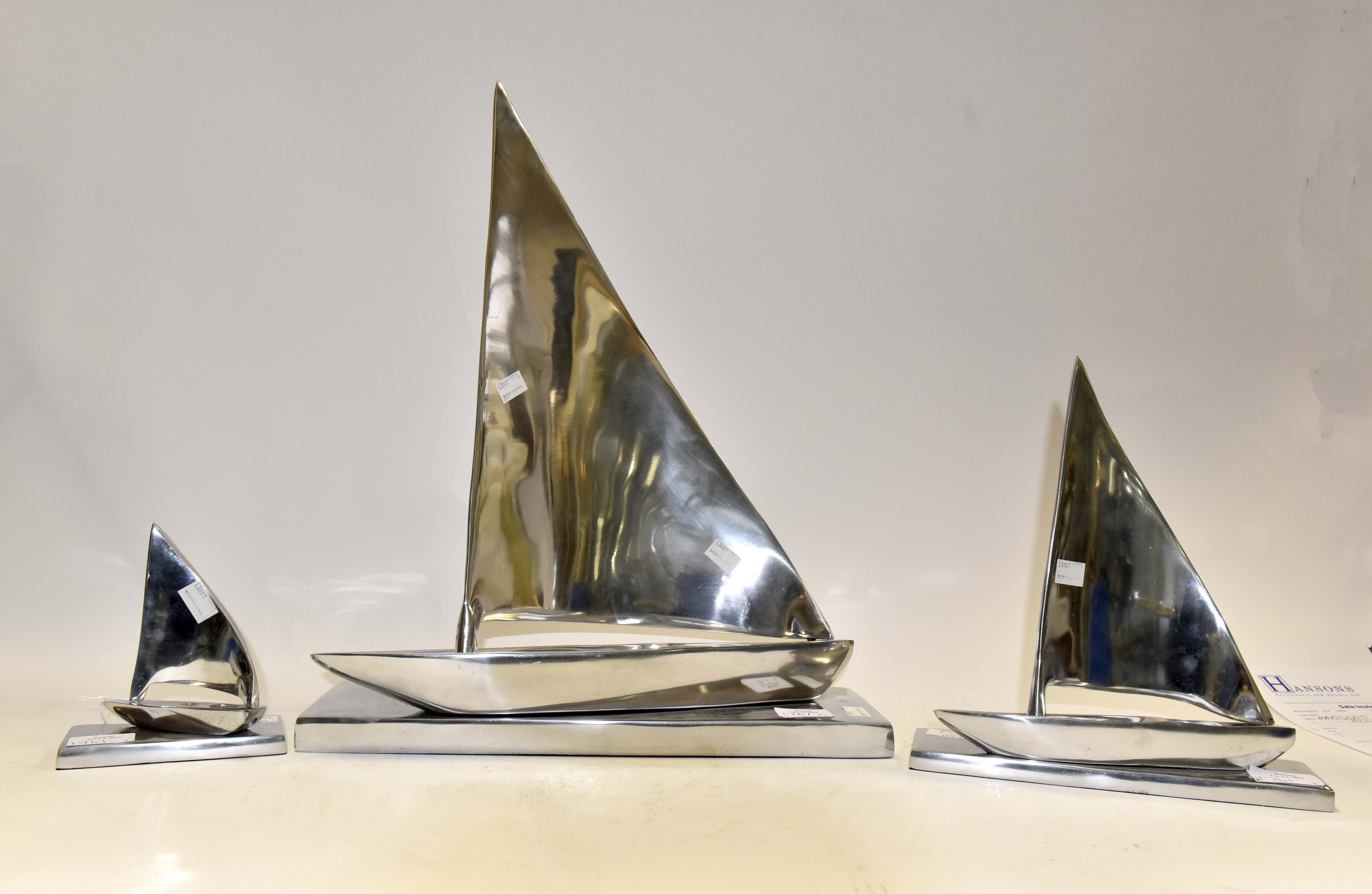 Three contemporary Stainless Steel Yacht group of figures,