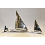 Three contemporary Stainless Steel Yacht group of figures,