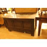 An early 18th Century oak joined mule chest, having a carved front, fitted with two drawers below,