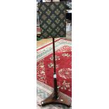 An early 19th Century rosewood pole screen, woolwork panel, turned and reeded column,