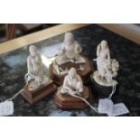 A series of four Indian ivory carvings, early 20th Century, one a lady with a basket,