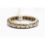 A white metal and diamond eternity ring, (white metal assessed as platinum,