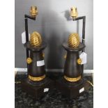 A pair of cast iron and bronze Empire style candlesticks, with wrythen pommels and later shade,