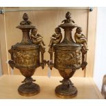 A pair of mid 19th Century urns, circa 1840, cast metal, gilded, decorated with cherubs and grapes,