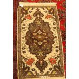 Small green rug with floral pattern