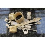 Mixed lot of small ivory pieces to include miniature elephant figures, menu clips,