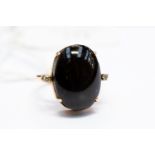 A yellow gold, black star diopside and diamond ring, the central cabochon diopside approx.