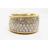 A diamond pave-set white and yellow ring,